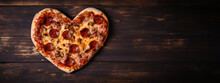 Heart-shaped Pizza On A Wooden Table. Pizza, Food, Love, Romance, Valentine's Day Concept.