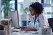 Portrait of a Black Female Medical Health Care Professional Working on Desktop Computer in Hospital Office. Clinic Head Nurse is Appointing Prescriptions Online Updating Electronic Health Records