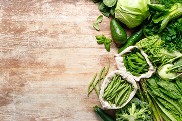 Poster - Vegetables background. Various green vegetables on kitchen table. Clean eating, healthy food concept, flat lay, top down view