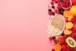 Fresh fruits and oats on a vibrant pink background, perfect for healthy eating concept