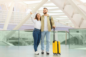 Happy young couple enjoying their time at the airport while waiting flight