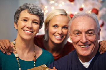 Wall Mural - Christmas, tree and senior family in portrait with love, happy and gratitude for holiday and tradition at night. Face of elderly parents with daughter and gift, present and celebration at their home