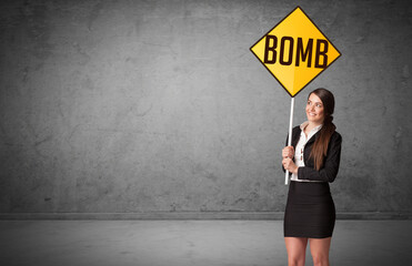 Wall Mural - Young business person holding road sign