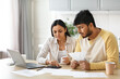 © Prostock-studio - Unhappy millennial indian couple working on family budget