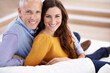 © ArcursJointTeam/peopleimages.com - Couple, age difference and happy for love in unique relationship, portrait and support for trust at home. Senior man, young woman and marriage, commitment and loyalty with partner and pride together