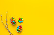 Happy Easter background with chocolate eggs and spring branch, top view