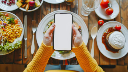 Young woman hands holding cell phone touching finger mock up blank display while breakfast, empty screen for social media, calories counter app. Mobile application tech concept. Dieting, balanced menu