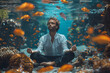 Under the sea portrait of a handsome man holding a breath on a sandy bottom in a yoga lotus position