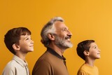 Fototapeta Kwiaty - Elderly man with two young boys, all smiling and looking in the same direction, embodying happiness and shared perspective. Happy Grandfather and Grandsons Looking Forward