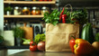 Closeup paper bag full of various vegetables on the kitchen table including red pepper or paprika, tomato, zucchini, parsley herb and onion. Different vegan food nutrition from supermarket shopping