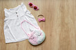 Set of baby girl dress and unicorn handbag. Kids wear flat lay