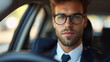 Young businessman in the glasses in the modern car
