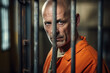 © Tetiana - Criminals jailed in prison in orange uniform behind metal bars Generative AI realistic 3D picture