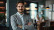 © Akmalism Photography - Happy successful businessman or company employee standing in office looking at camera.