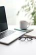 © Darya - Minimalist Workspace: Laptop, Coffee, and Glasses in a Home Office