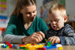 © Paula - Therapist engaging with young child during educational play