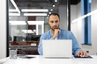© Tetiana - Professional man working on laptop in modern office