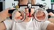 © Nadzeya - Girl holding trial frame for medical optics clinic concept. Choosing spectacle lenses for children