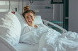 © AAA - lone woman is smiling in a medical hospital bed