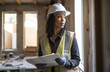 Confident Female Engineer with Plans on Construction Site