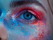Vibrant eye makeup close-up, with blue and red hues and colorful glitter