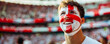 Happy English male supporter with face painted in English flag consists of a white field (background) with a red cross, English male fan at a sports event such as football or rugby match