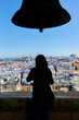Woman in silhouette looking towards Cadiz with sea and cruise ship in the background