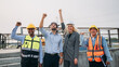 © NewSaetiew - Four construction workers are standing together, all wearing hard hats