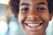 © igorfrost - smiling teenage african boy with braces, close up portrait of black teen, orthodontic treatment, blurred background