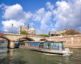 Fototapeta  - Paris, Notre Dame cathedral with boat on Seine in France