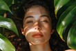 a young woman glows amid lush, green foliage while exploring hydration therapy, her skin radiant