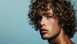 Young Man with Curly Hair and Intense Blue Eyes