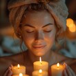 a young woman tenderly applies moisturizer, her glowing complexion illuminated by candlelight for added warmth