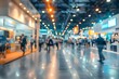 © Anastasiia - Blurred image of a busy trade show with various company booths. Concept Trade Show, Busy Environment, Company Booths, Blurred Image, Crowded Venue
