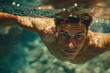 man swimming underwater with eyes wide open, summer concept