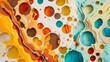 Artistic cut-out of colorful ink droplets on layered paper surface in orange, yellow, blue, and brown for a creative abstract design