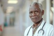 Portrait of african american mature doctor on blurred white clinic background
