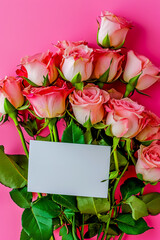 Wall Mural - Bouquet of beautiful fresh roses with a card on pink background, top view.