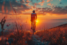 Silhouette Of Cyclist On A Gravel Bike Riding On A Dust Trail At Countryside During Sunset.