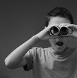 © herlanzer - boy looking through toy binoculars toilet paper roll with people stock image stock photo