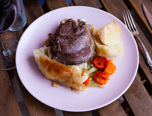 Sticker - Pork cheeks with stewed cabbage leaves. Spanish cuisine