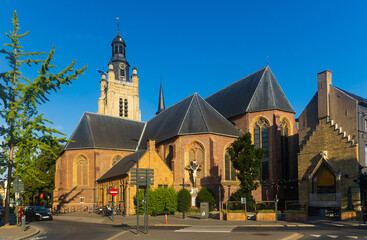 Wall Mural - View of Sint-Michielskerk parish church with tall bell tower in Belgian town of Roeselare on sunny summer day, West Flanders