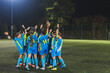 © PoppyPix - teenage girls football team preparing for match and encouraging each other, blue uniforms, active and sport life. High quality photo