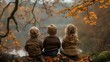 © Katsiaryna - Back view of three kids sitting on a tree branch in autumn forest