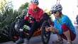 © Robert Peak - Senior and mature woman take a break while biking to look at a map on their phone for directions.