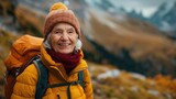 Fototapeta  - An old woman who happily travels the mountain scenic spots
