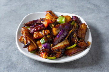 A view of a plate of Sichuan stir fried eggplant.