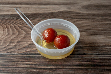 A view of a container of gulab jamun.