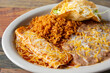 © DAVID - A view of a combo plate, featuring an enchilada, hard taco, rice and beans.