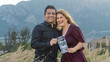 © Zkidstock - young hispanic couple laughing and holding an ultrasound looking at the horizon